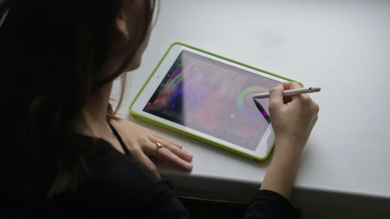Dois monitores lado a lado exibindo telas de edição visual com diversas artes